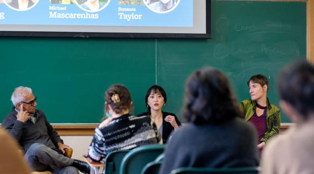 A group of people talking on a panel discussion