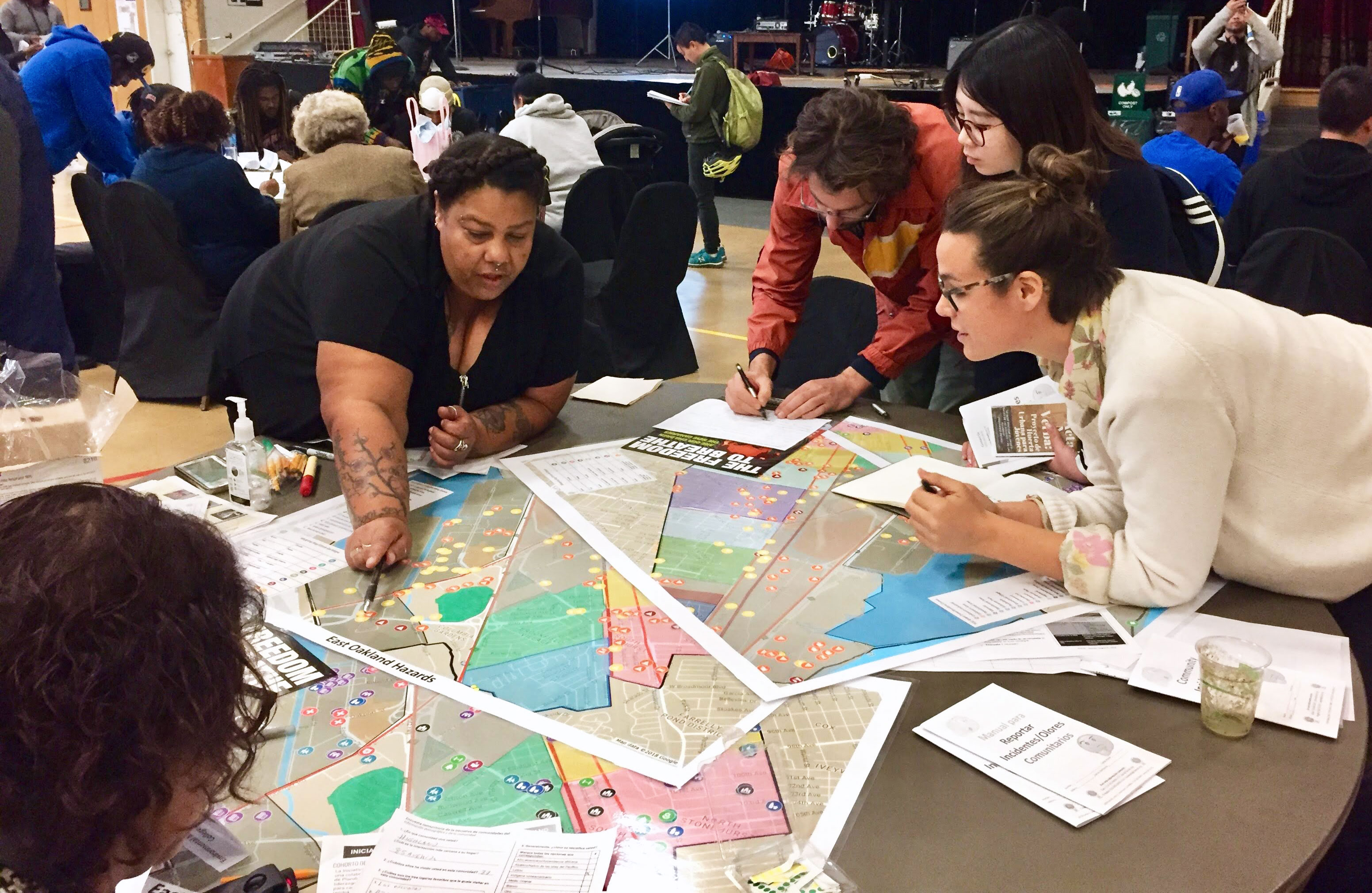 A group of people standing looking at the a map