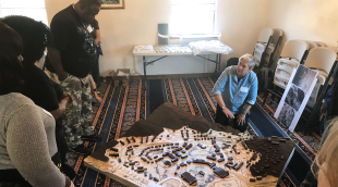 A researcher showing a 3d map to a group